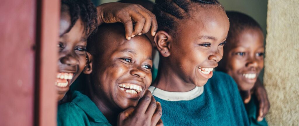 Children smiling at orphanage - Africa Renewal Ministries Australia